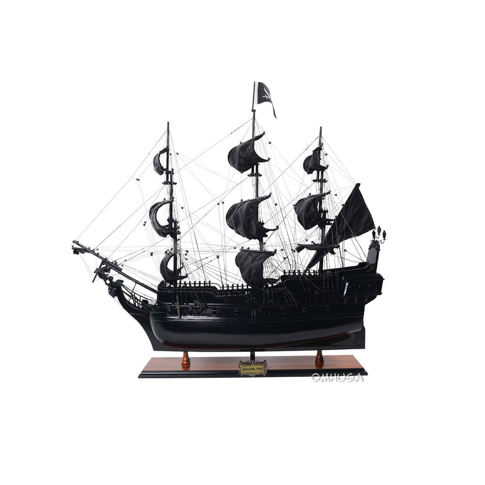 Handcrafted wooden tall ship model with dark hull and full sails